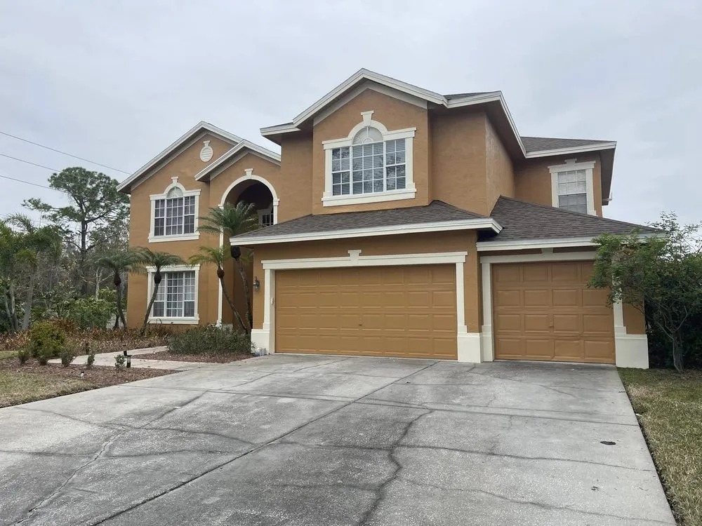Freshly painted two-story home with a three-car garage