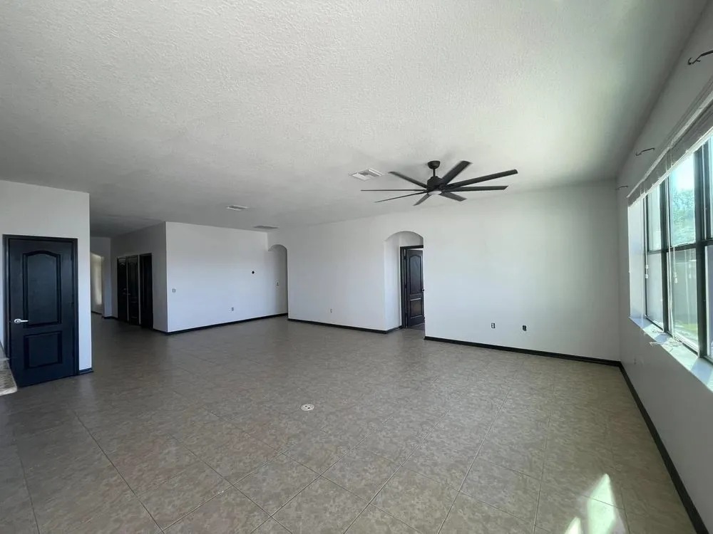 Large open room with freshly painted white walls