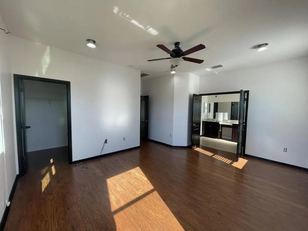 Empty room with fresh white walls and black painted doors