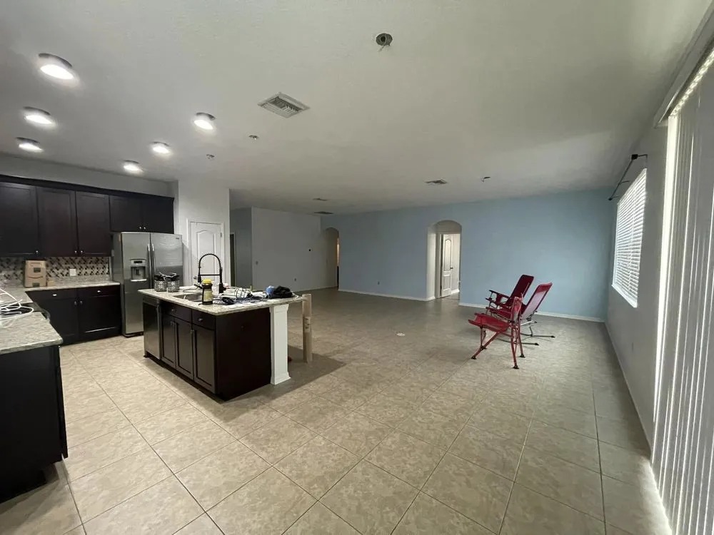 Open kitchen and living area with light blue walls in a Pasco County home